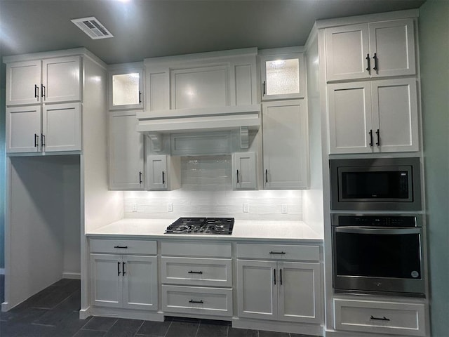 4140 Peony Cir, Piedmont, OK 73078 - kitchen featuring stainless steel appliances, white cabinetry, light countertops, glass insert cabinets, and dark tile patterned floors