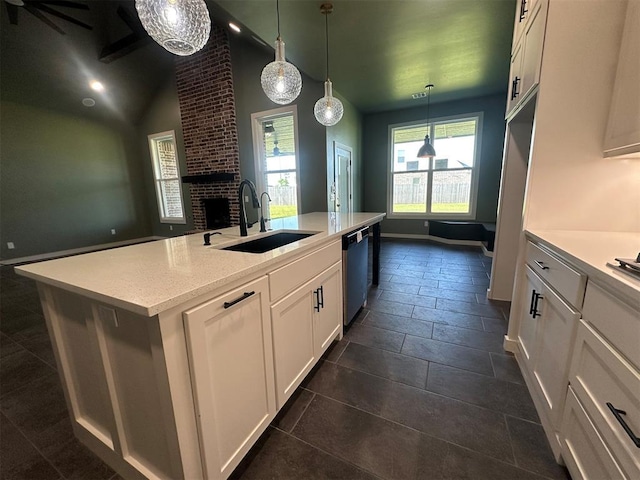 4140 Peony Cir, Piedmont, OK 73078 - kitchen featuring a brick fireplace, stainless steel dishwasher, white cabinetry, a center island with sink, and decorative light fixtures