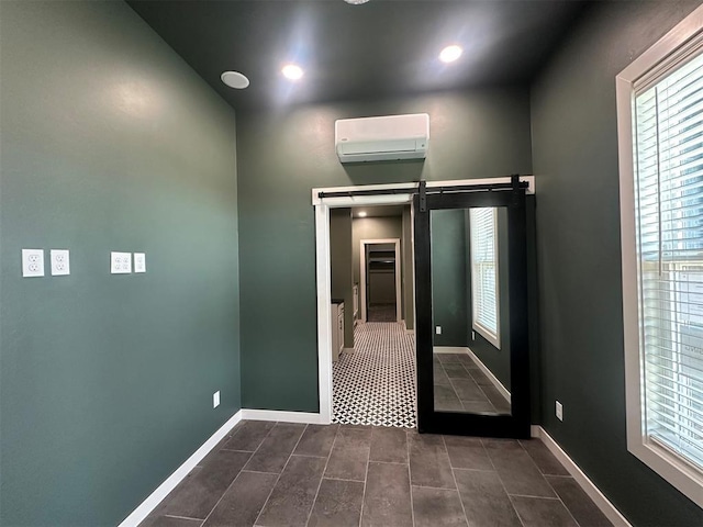4140 Peony Cir, Piedmont, OK 73078 - spare room with a wall mounted air conditioner, a barn door, dark tile patterned flooring, and recessed lighting