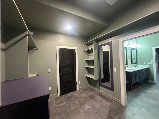 4140 Peony Cir, Piedmont, OK 73078 - spacious closet featuring dark tile patterned floors