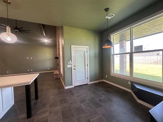 4140 Peony Cir, Piedmont, OK 73078 - unfurnished dining area featuring dark tile patterned floors and baseboards