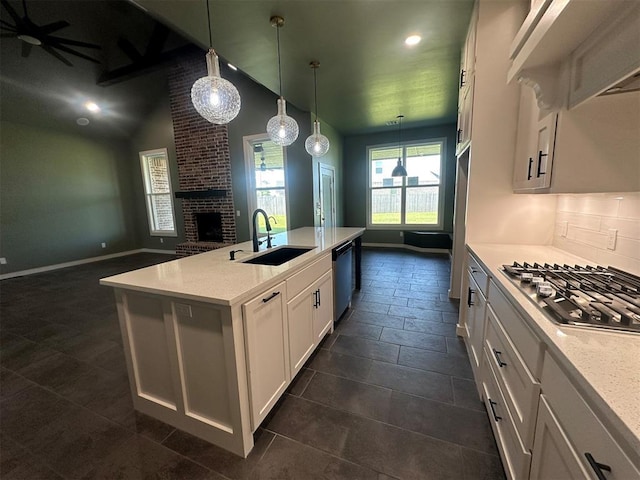 4140 Peony Cir, Piedmont, OK 73078 - kitchen featuring appliances with stainless steel finishes, a brick fireplace, open floor plan, white cabinets, and decorative light fixtures