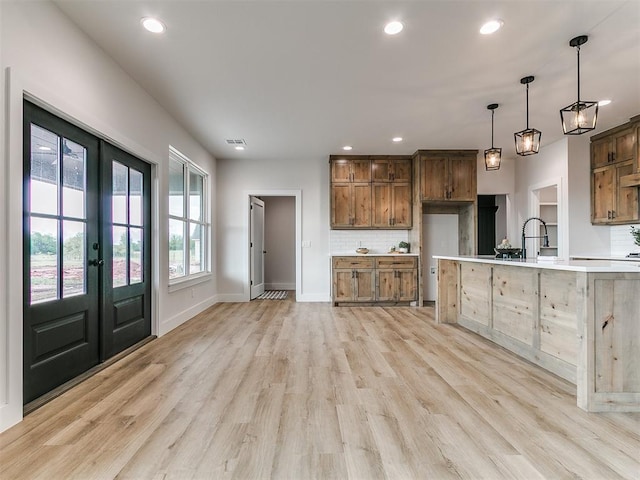 kitchen with recessed lighting, tasteful backsplash, and light wood-style floors