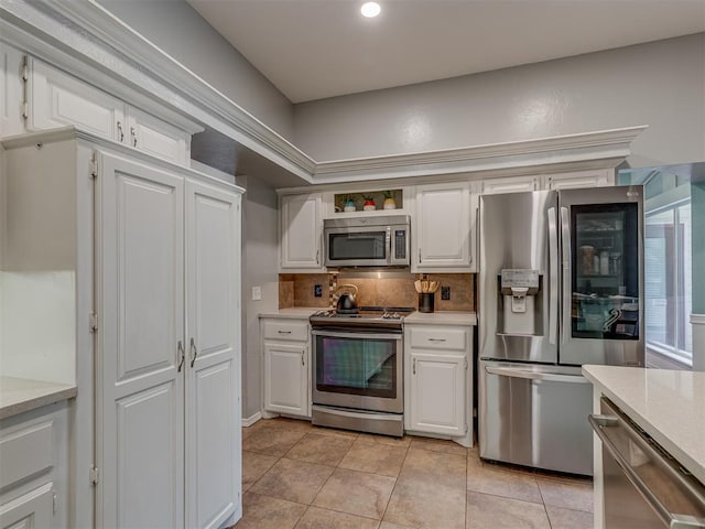 kitchen featuring white cabinetry, light tile patterned floors, appliances with stainless steel finishes, and light countertops