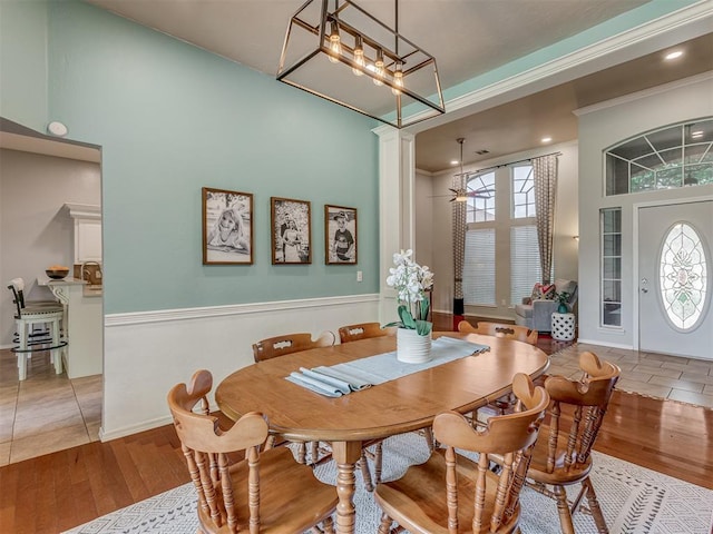 dining room featuring a high ceiling, wood finished floors, and plenty of natural light