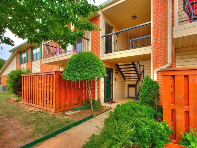 exterior space featuring central AC unit and a balcony