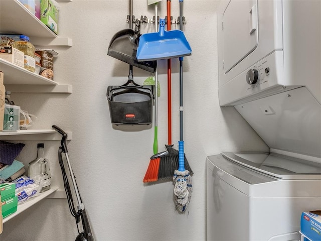 clothes washing area featuring laundry area and stacked washer and clothes dryer
