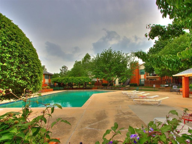 view of pool featuring a fenced in pool, a patio area, and fence