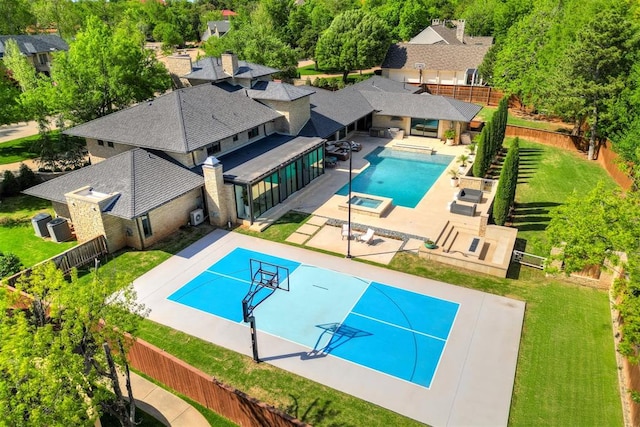 view of pool featuring a fenced backyard, a yard, a tennis court, and a pool with connected hot tub