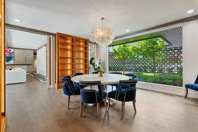 dining area with a chandelier, visible vents, wood finished floors, and recessed lighting