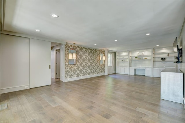 unfurnished living room featuring recessed lighting, wallpapered walls, baseboards, and light wood-type flooring