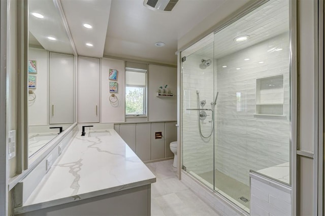 full bath with vanity, toilet, recessed lighting, a shower stall, and visible vents