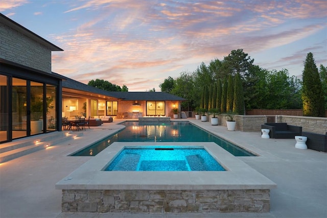 view of pool with an outdoor hangout area, a fenced in pool, a patio, and an in ground hot tub