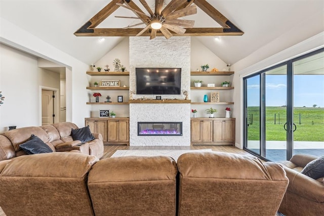 living room with a ceiling fan, high vaulted ceiling, beamed ceiling, a fireplace, and light wood-type flooring