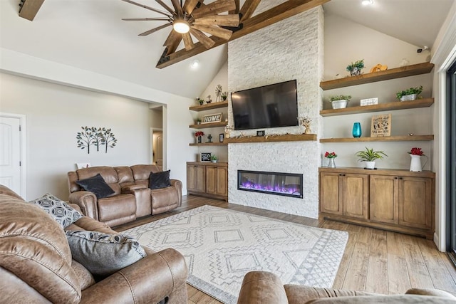 living area with high vaulted ceiling, recessed lighting, a fireplace, ceiling fan, and light wood-style flooring