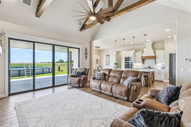 living room with light wood-type flooring, a ceiling fan, and visible vents