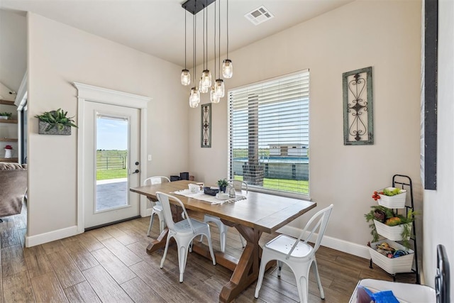 dining area featuring visible vents, baseboards, plenty of natural light, and wood finished floors