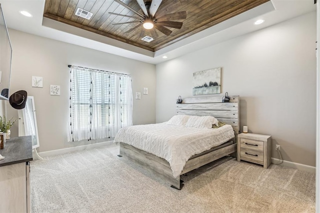 bedroom featuring wooden ceiling, baseboards, visible vents, a raised ceiling, and light carpet
