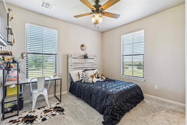 bedroom with ceiling fan, carpet flooring, baseboards, and visible vents