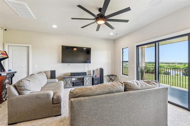 living area with a ceiling fan, visible vents, and recessed lighting