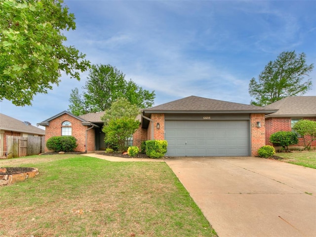 ranch-style house featuring a garage, a front lawn, fence, brick siding, and driveway