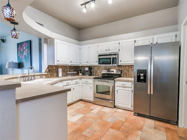 kitchen featuring a sink, appliances with stainless steel finishes, backsplash, and white cabinetry