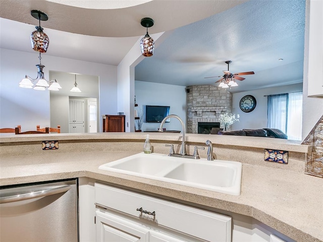 kitchen featuring decorative light fixtures, ceiling fan, a sink, and dishwasher