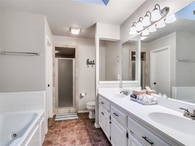 full bathroom featuring toilet, a shower stall, a sink, and a whirlpool tub