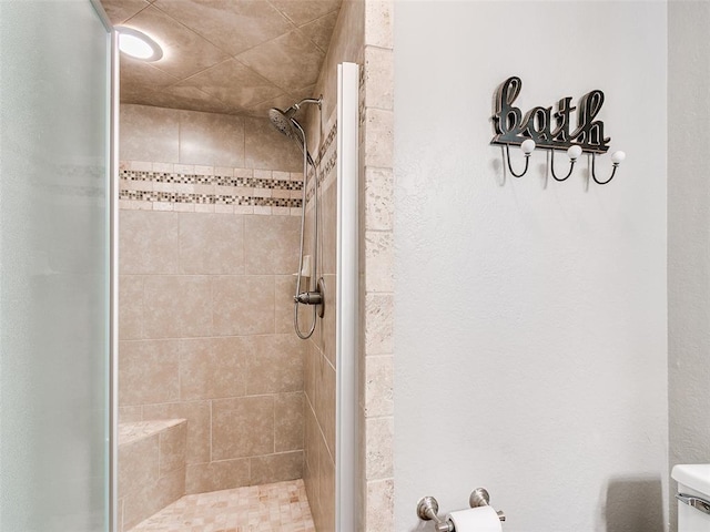 bathroom with toilet and a shower stall