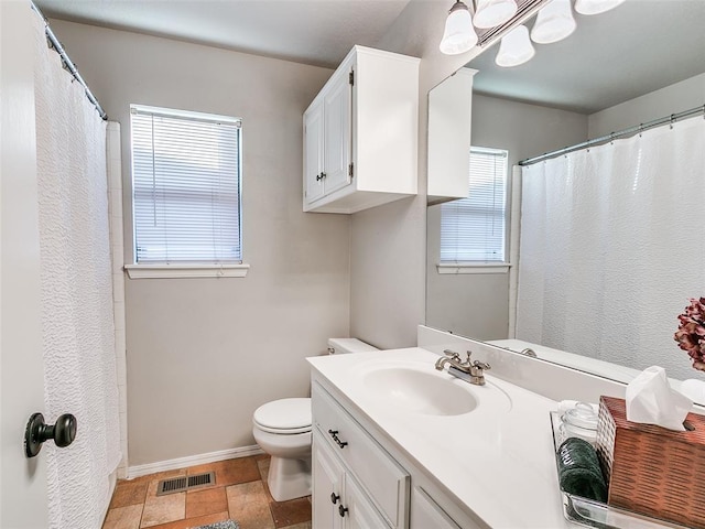 full bathroom featuring vanity, toilet, stone finish floor, baseboards, and visible vents