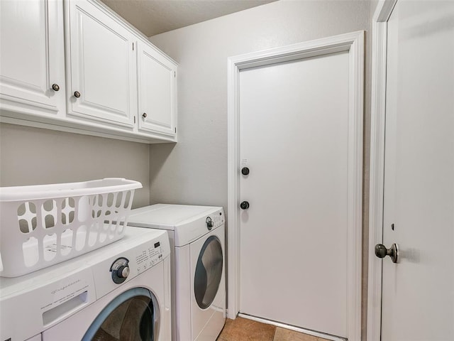 laundry area featuring cabinet space and washing machine and clothes dryer