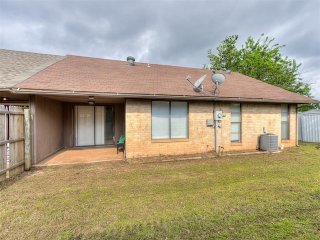 3800 Southwind Ct, Oklahoma City, OK 73179 - back of house featuring roof with shingles, a patio area, and brick siding