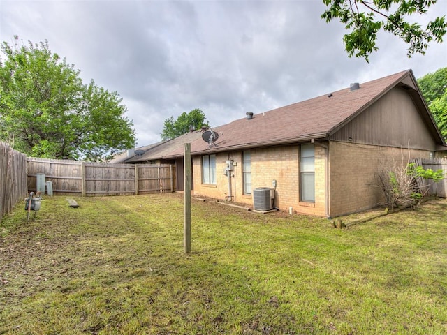 3800 Southwind Ct, Oklahoma City, OK 73179 - rear view of property with a fenced backyard, brick siding, and a shingled roof