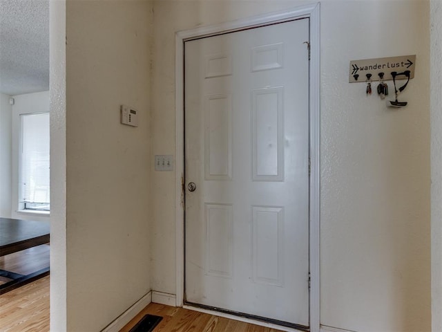 3800 Southwind Ct, Oklahoma City, OK 73179 - entryway with light wood finished floors and a textured ceiling