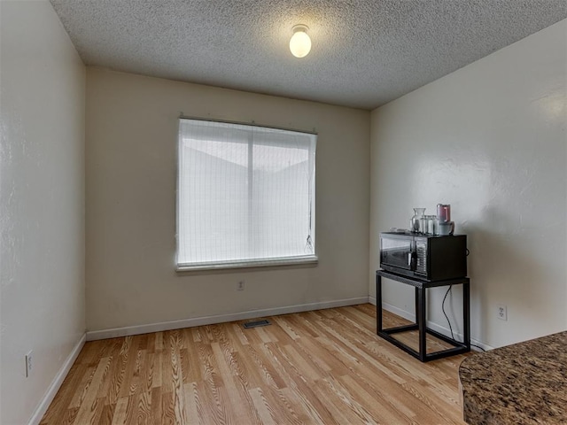 3800 Southwind Ct, Oklahoma City, OK 73179 - empty room with wood finished floors and a textured ceiling
