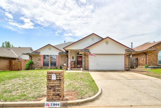 7904 NW 81st St, Oklahoma City, OK 73132 - view of front of home featuring concrete driveway, fence, an attached garage, and brick siding