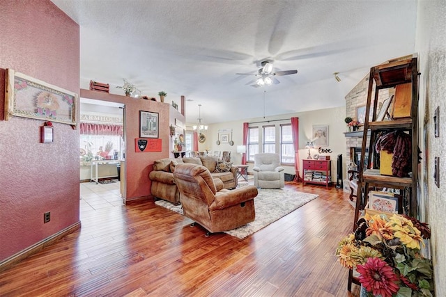 7904 NW 81st St, Oklahoma City, OK 73132 - living room featuring a healthy amount of sunlight, wood finished floors, and ceiling fan with notable chandelier