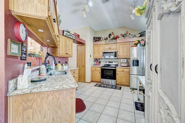 7904 NW 81st St, Oklahoma City, OK 73132 - kitchen with light tile patterned floors, appliances with stainless steel finishes, vaulted ceiling, a sink, and visible vents