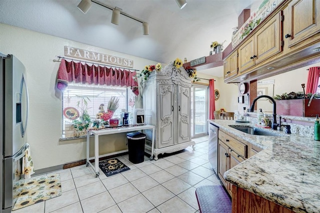 7904 NW 81st St, Oklahoma City, OK 73132 - kitchen featuring lofted ceiling, light tile patterned floors, a sink, appliances with stainless steel finishes, and track lighting