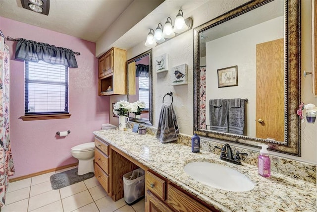 7904 NW 81st St, Oklahoma City, OK 73132 - bathroom featuring toilet, tile patterned flooring, a wealth of natural light, and vanity
