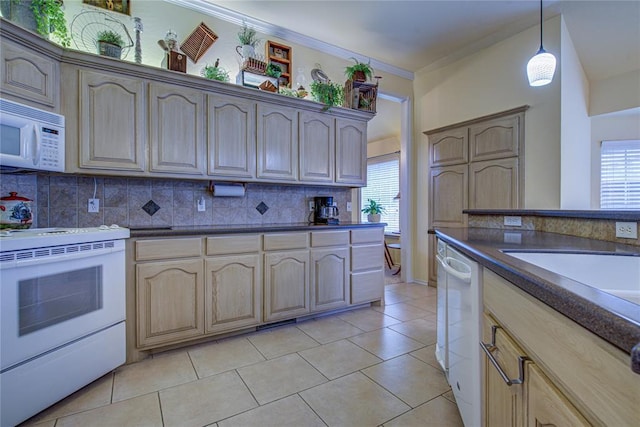 kitchen featuring decorative backsplash, dark countertops, a wealth of natural light, and white appliances
