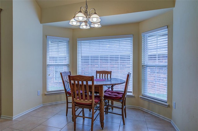 dining area featuring plenty of natural light, light tile patterned floors, and a chandelier