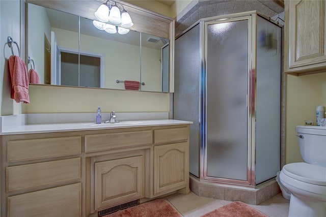 full bath with vanity, a stall shower, tile patterned floors, and toilet