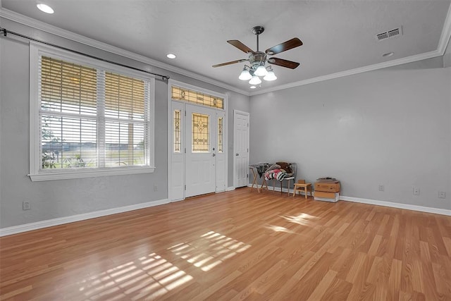 entryway with visible vents, baseboards, ornamental molding, light wood finished floors, and a ceiling fan