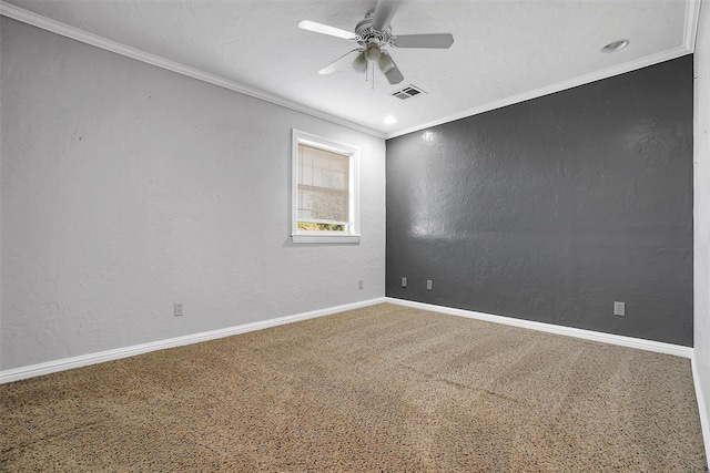 carpeted spare room with ceiling fan, visible vents, a textured wall, baseboards, and ornamental molding