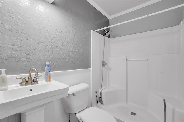 bathroom featuring a shower, toilet, a wainscoted wall, and ornamental molding