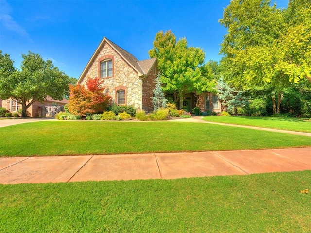 view of front facade featuring a front yard and stone siding