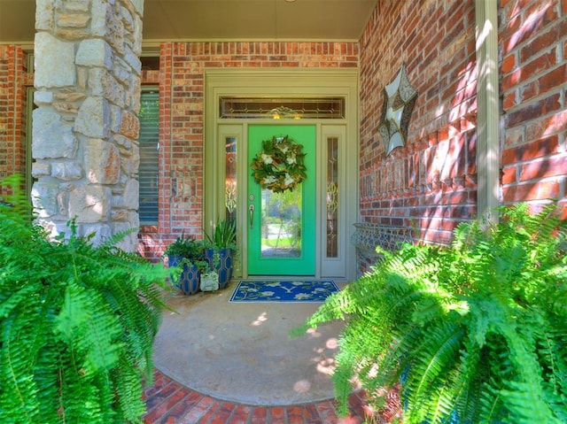 doorway to property with brick siding