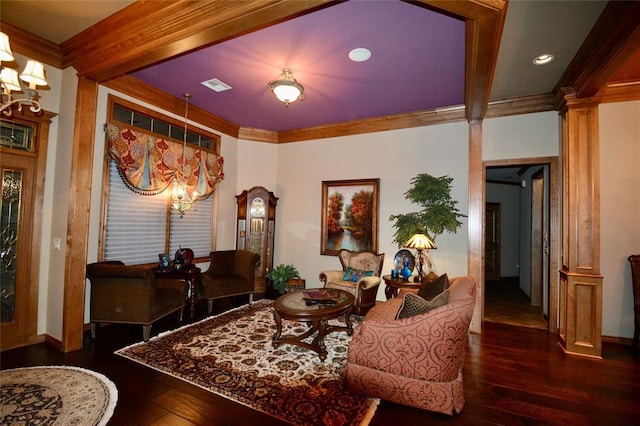 interior space featuring visible vents, hardwood / wood-style flooring, ornate columns, and crown molding