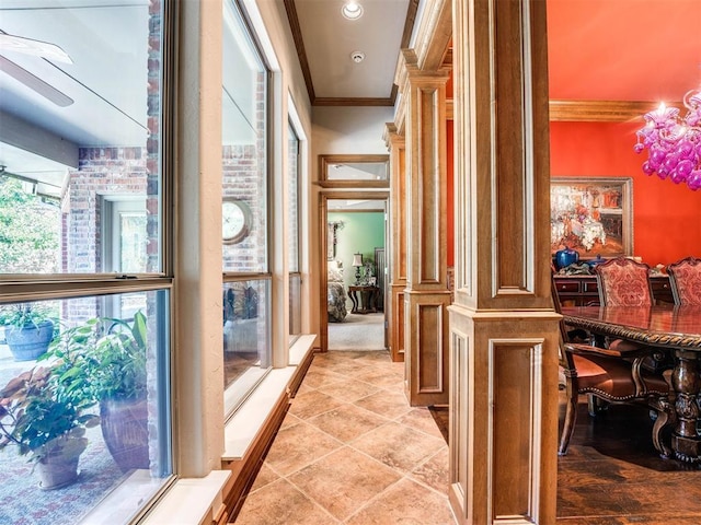 hall with light tile patterned floors and ornamental molding